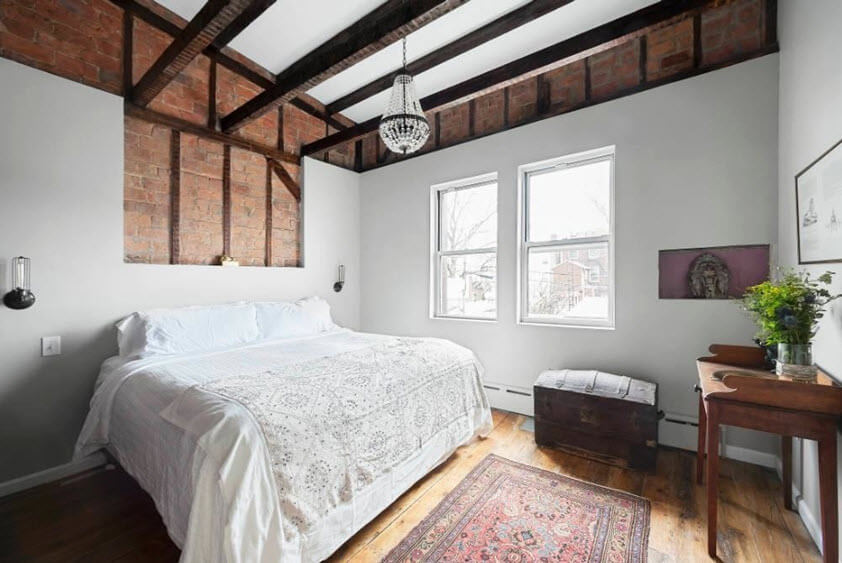 bedroom wood floors ceiling beams area rug